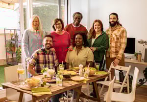 group-of-friends-gathering-around-table-with-food-2025-02-21-03-21-29-utc