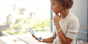 woman pondering something on tablet screen