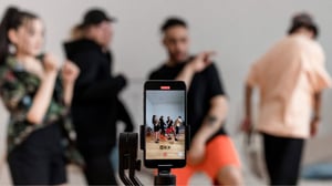 People dancing while filming themselves on a cell phone