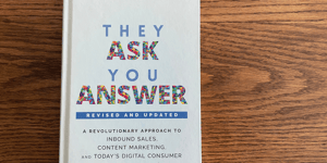 cover of They Ask, You Answer book on wood background