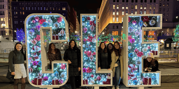 Ready North team posing with a Cleveland Christmas sign