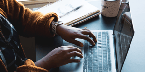 woman typing on laptop