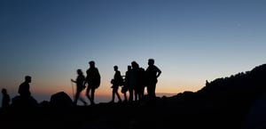 Team hiking at dusk