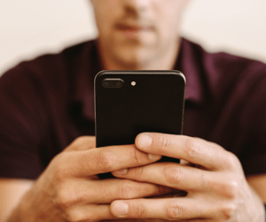 man looking at cell phone