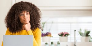 Woman looking at computer pondering