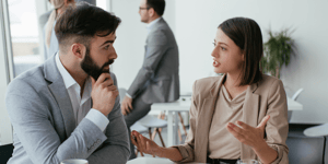 a man and a woman at work in the middle of a discussion