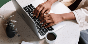 person typing on computer_canva