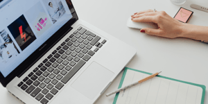 woman using a mouse with her laptop