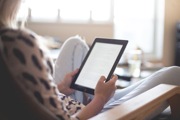 woman-sitting-on-chair-using-black-ipad-196649-1