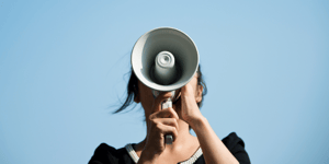 person speaking into a megaphone
