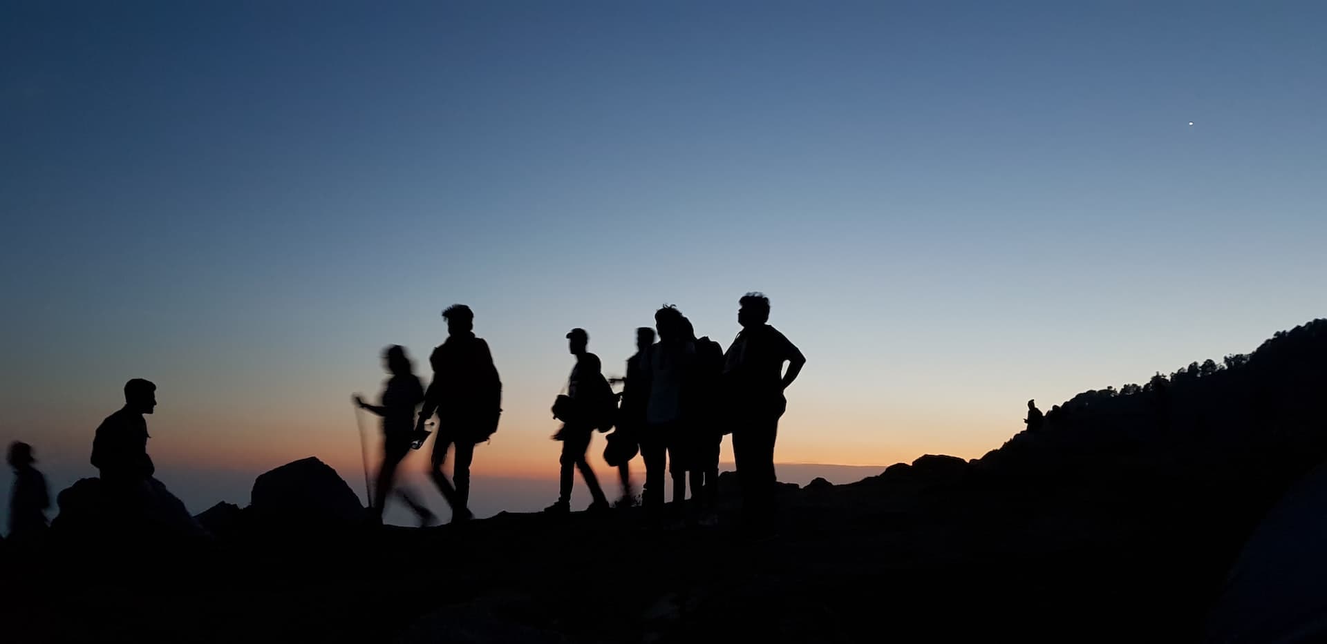 Team hiking at dusk